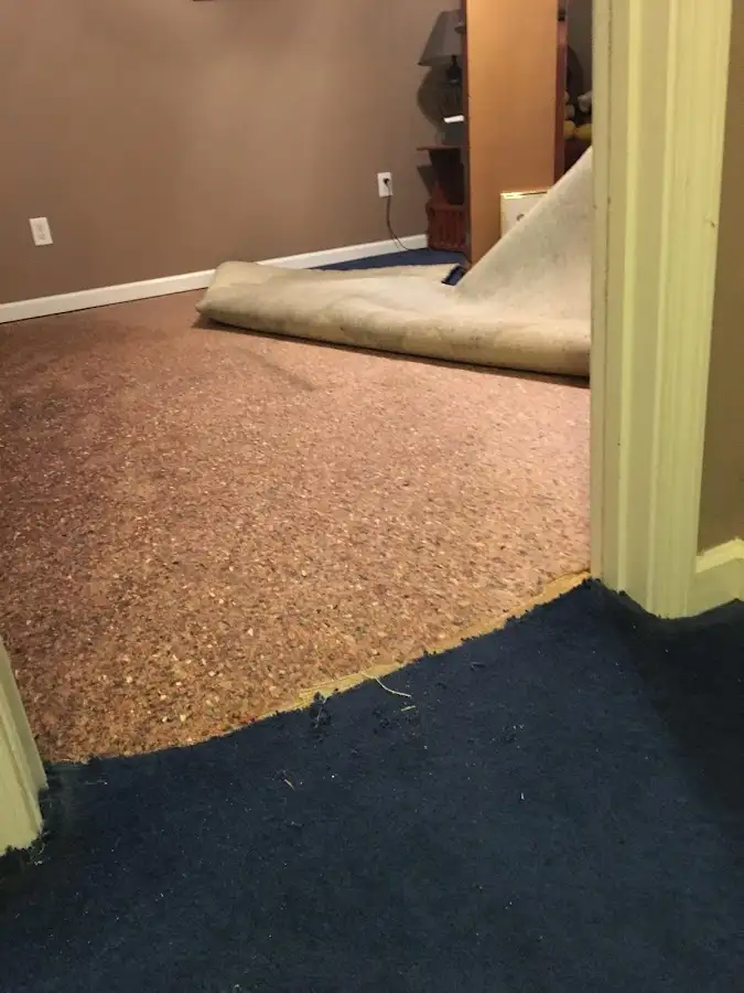 Carpet pad removal revealing water damage during Drying & Dehumidification in East Kapolei